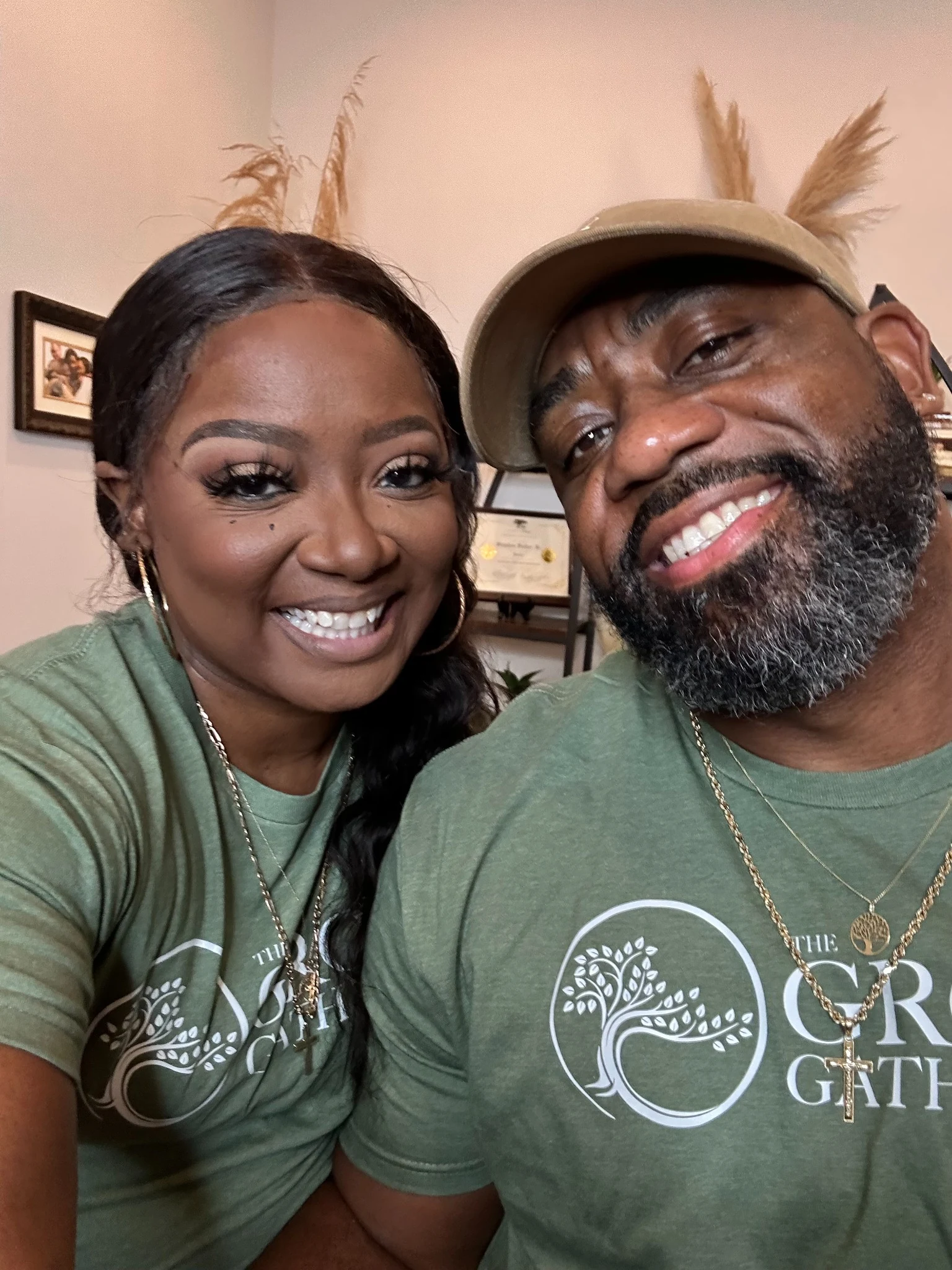 Two people wearing green The Grow Gathering shirts